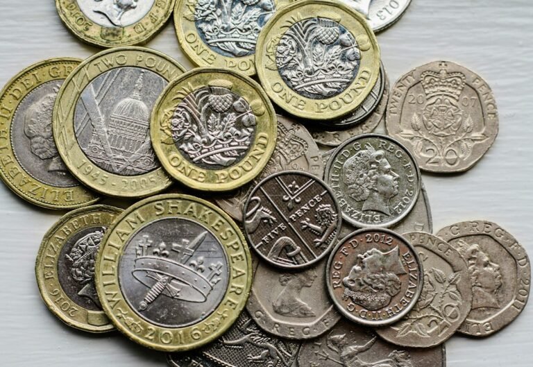 UK sterling coins representing Cash ISA versus Stocks and Shares ISA comparison