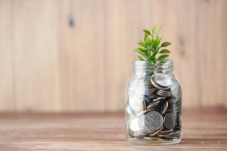 Savings jar with coins representing comparison of ISA providers in the UK