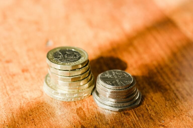 British pound coins representing ISA versus ordinary savings account comparison