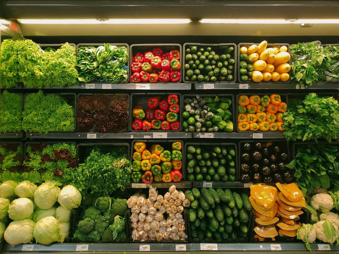 Fresh supermarket vegetables representing practical ways to spend less on groceries