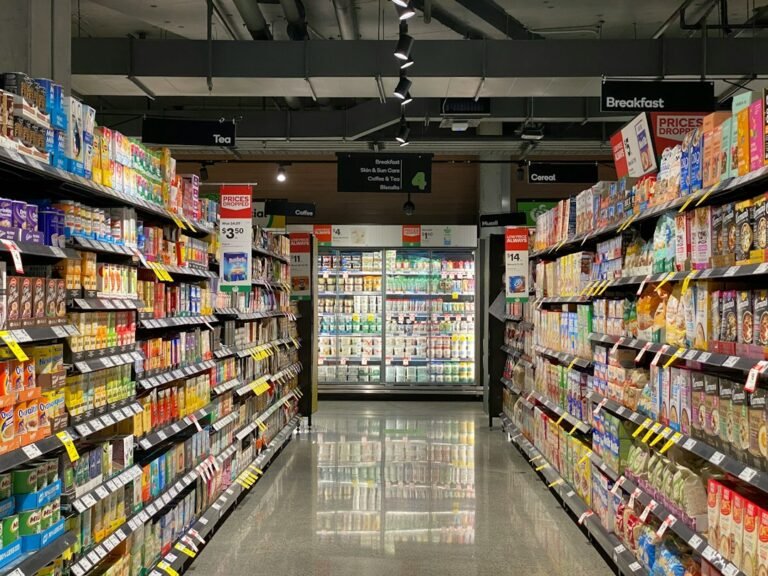 Supermarket shelves representing comparing branded and own-brand groceries