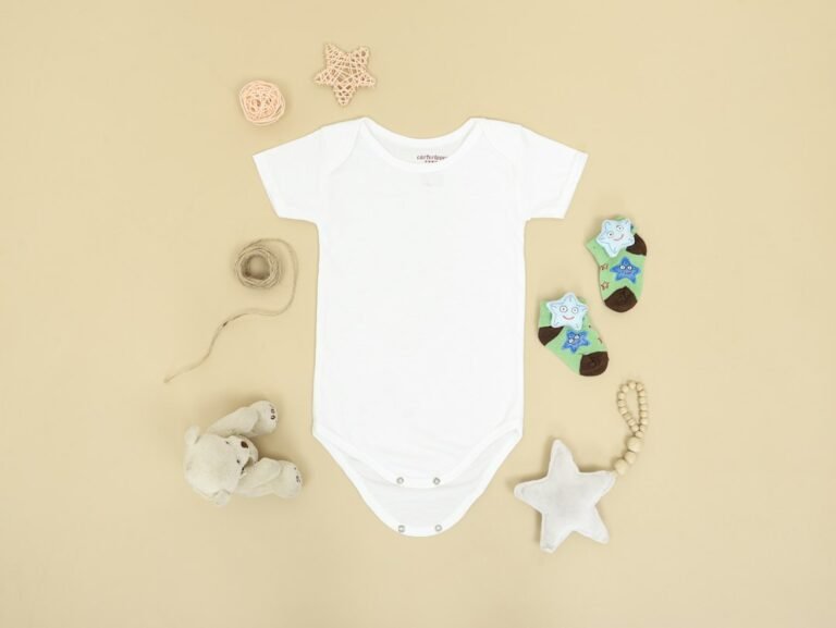 Baby clothes, socks and toys arranged as newborn essentials