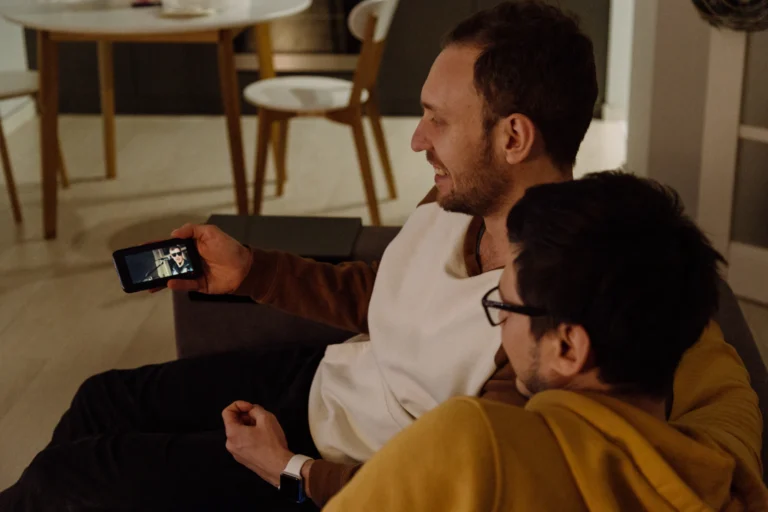 Two people watching a video together on a phone