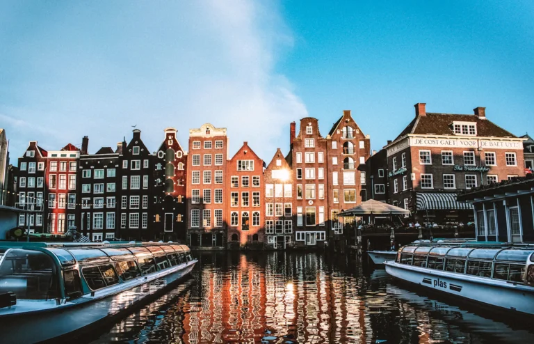 Canal boats and waterfront buildings in a European city.