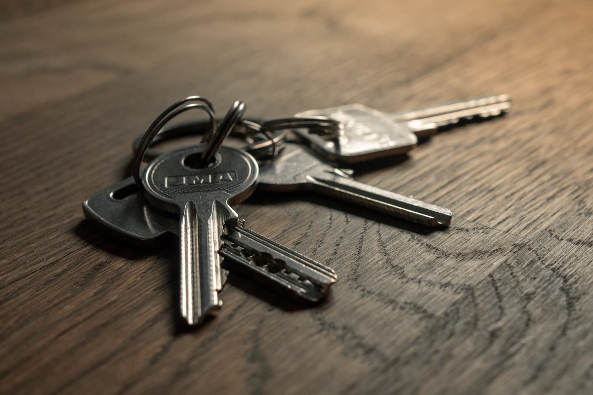 Keys resting on a wooden table, illustrating rental collection checks.