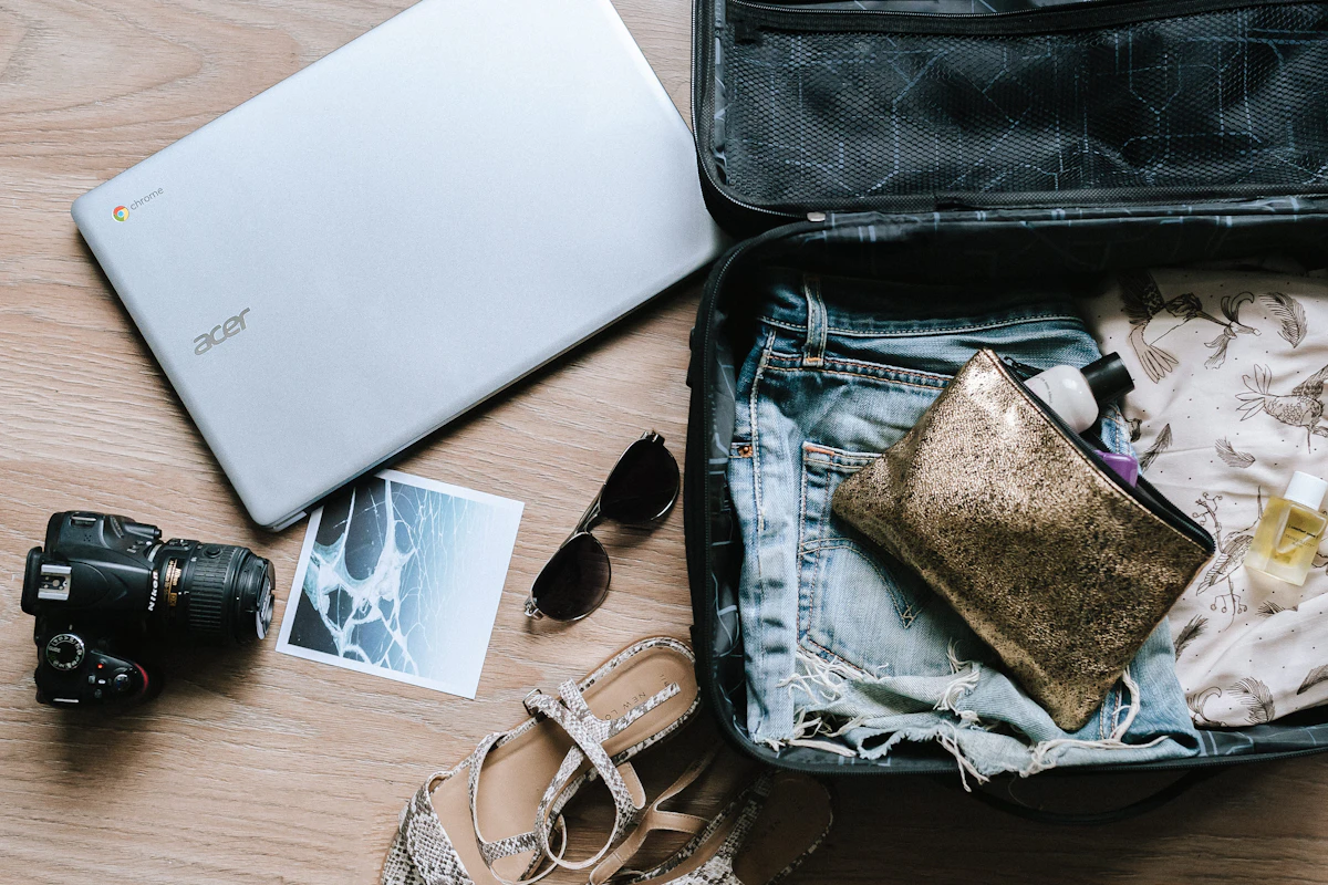 GHIC vs travel insurance: open suitcase and travel belongings, illustrating family travel preparation.