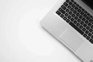 Laptop keyboard on a clear desk for preparing a digital download