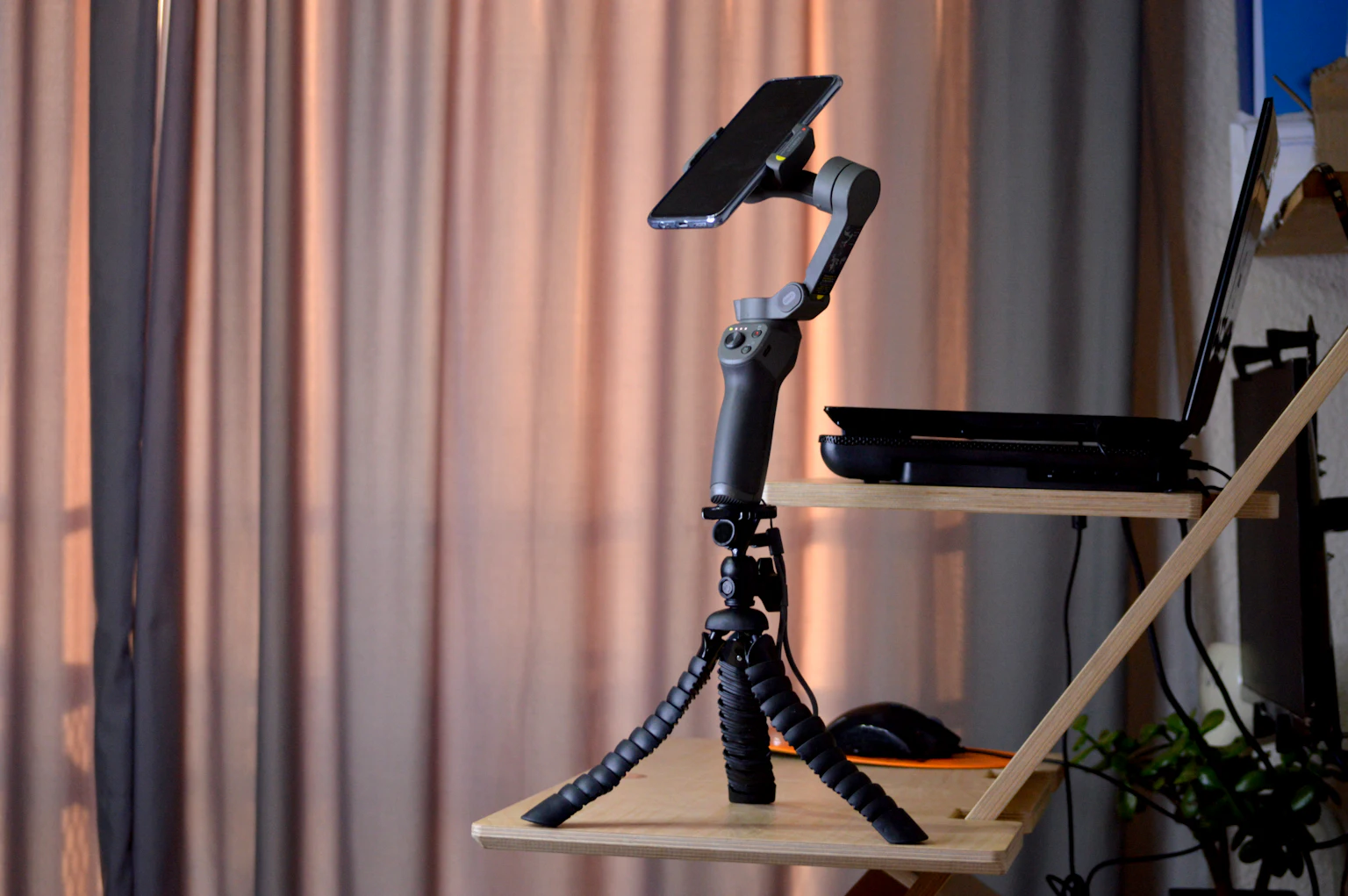 Phone mounted on a small tripod for filming