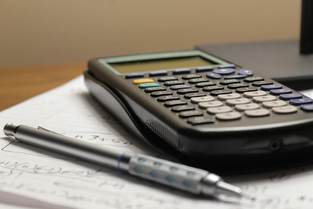 Calculator and paper used to plan an affordable emergency savings goal