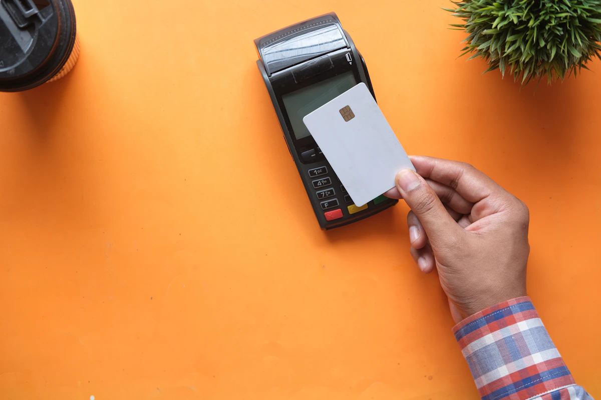 Blank payment card beside a terminal, illustrating overseas payment checks.