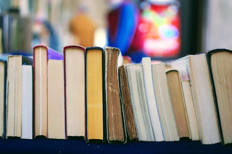 Row of used books with different covers and sizes